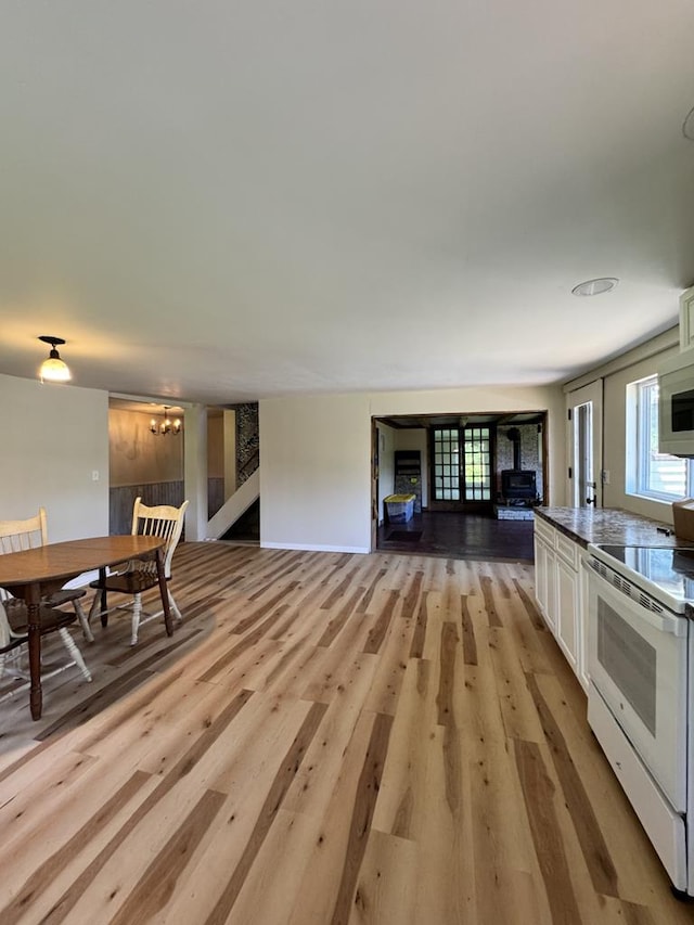 971 Indian Creek Rd, Eldred, PA 16731 - kitchen with white appliances, light wood-type flooring, white cabinetry, and open floor plan
