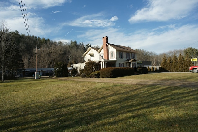 view of side of home with a yard