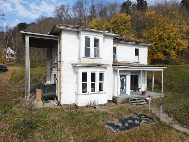 view of front of home with covered porch and a front lawn