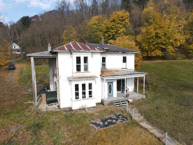 exterior space with a lawn and a porch