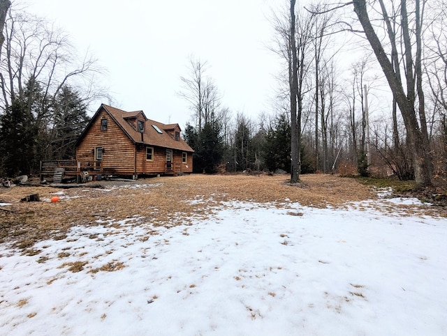 view of snowy exterior featuring a wooden deck