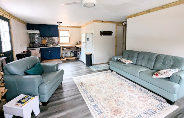 living area featuring light wood-style flooring and a ceiling fan