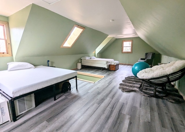 bedroom featuring vaulted ceiling and wood finished floors