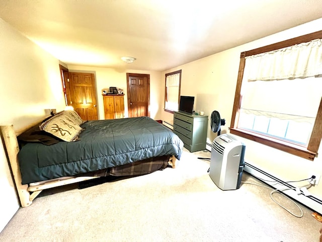 bedroom with a baseboard radiator and carpet