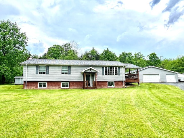 view of front of house featuring a wooden deck, a garage, an outdoor structure, and a front yard