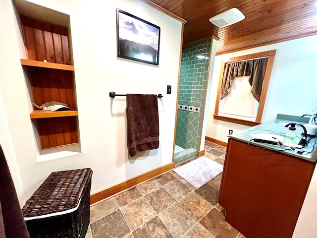 bathroom featuring wood ceiling, vanity, built in features, and a tile shower