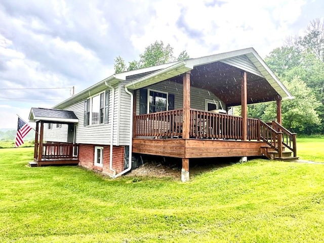 view of side of home with a deck and a lawn