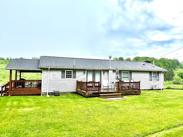 back of house featuring a wooden deck and a yard