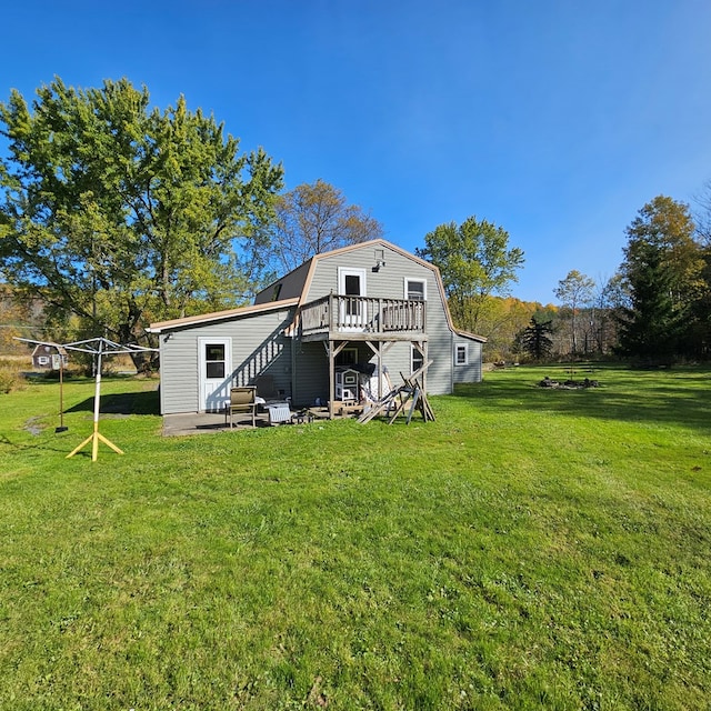 rear view of house with a yard and a deck