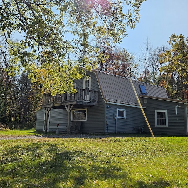 back of house featuring a deck and a yard