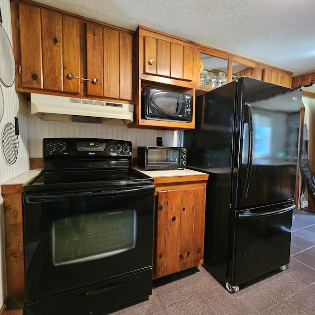 kitchen featuring black appliances and a textured ceiling