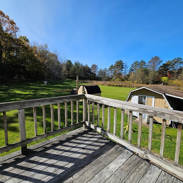 deck featuring a yard and a storage shed