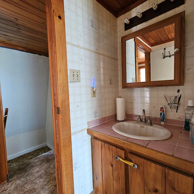 bathroom with decorative backsplash, vanity, and wooden ceiling