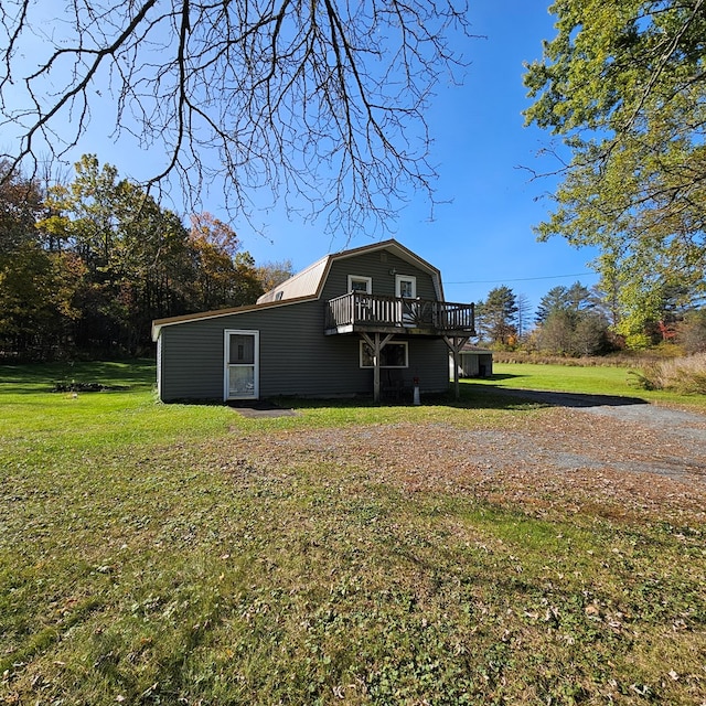 exterior space featuring a front lawn and a deck