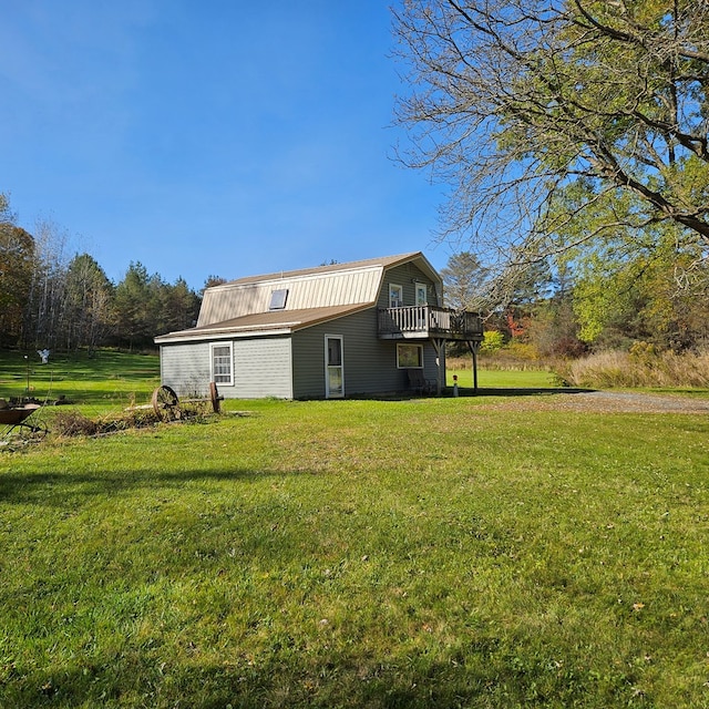 back of house with a lawn and a deck