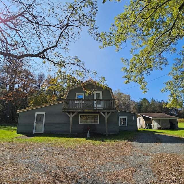 view of front of home featuring a carport and a wooden deck