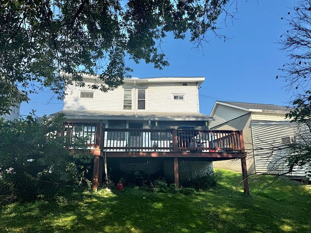 rear view of house with a lawn and a wooden deck