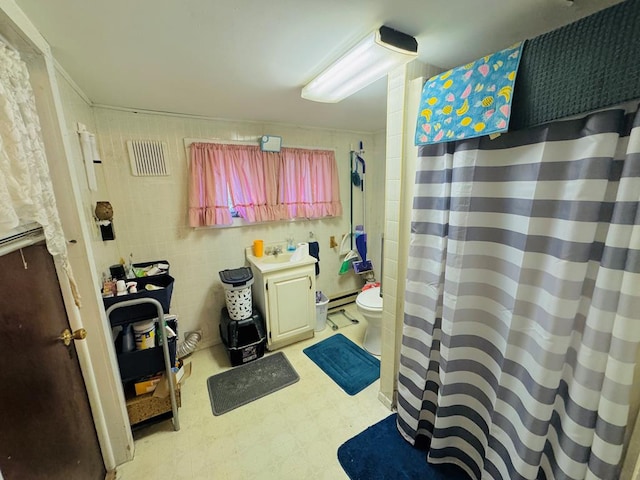 bathroom featuring a shower with curtain, sink, a baseboard radiator, and toilet