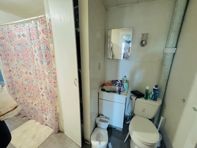 bathroom featuring curtained shower and toilet