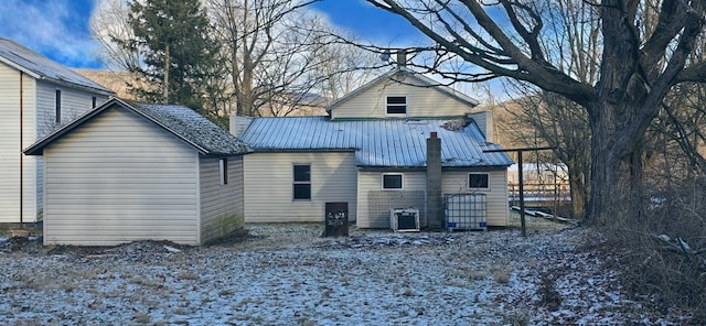 rear view of house with central AC unit