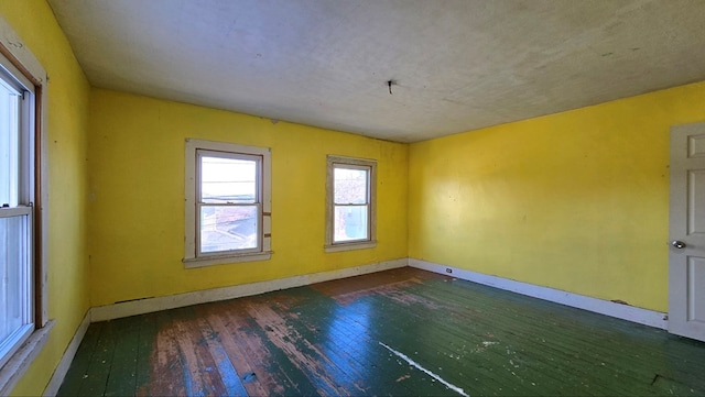 empty room featuring dark hardwood / wood-style floors and a textured ceiling