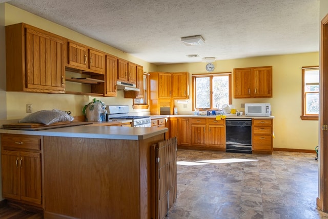 kitchen featuring a textured ceiling and white appliances