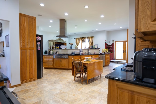 kitchen with sink, island exhaust hood, and appliances with stainless steel finishes