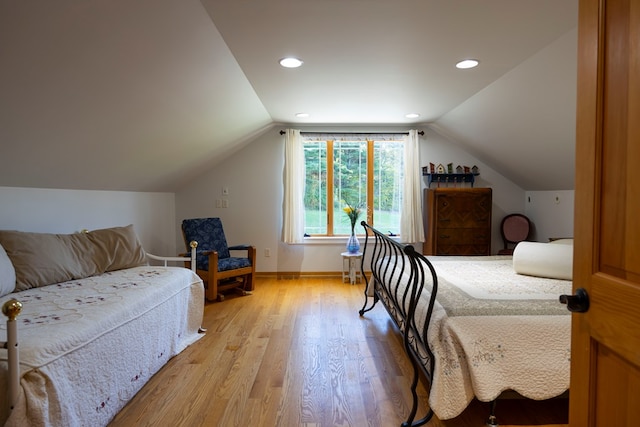 bedroom featuring vaulted ceiling and light hardwood / wood-style flooring