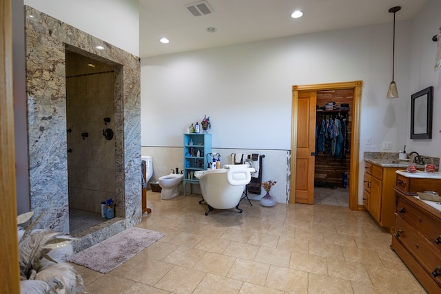 bathroom featuring vanity, separate shower and tub, and a bidet