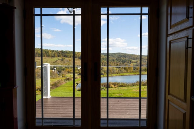 doorway to outside featuring a water view