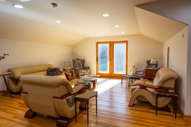 sitting room featuring light hardwood / wood-style floors and vaulted ceiling