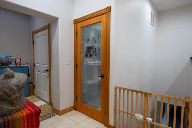 hallway with light tile patterned floors