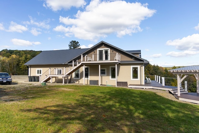 back of house with a balcony, central AC, a lawn, and a wooden deck