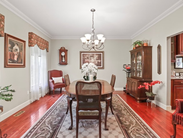 335 Sullivan Dr, Sayre, PA 18840 - dining area with a chandelier, crown molding, wood finished floors, and baseboards
