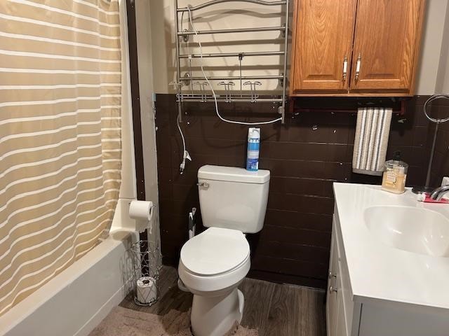 full bathroom with vanity, hardwood / wood-style flooring, toilet, and shower / bathtub combination with curtain