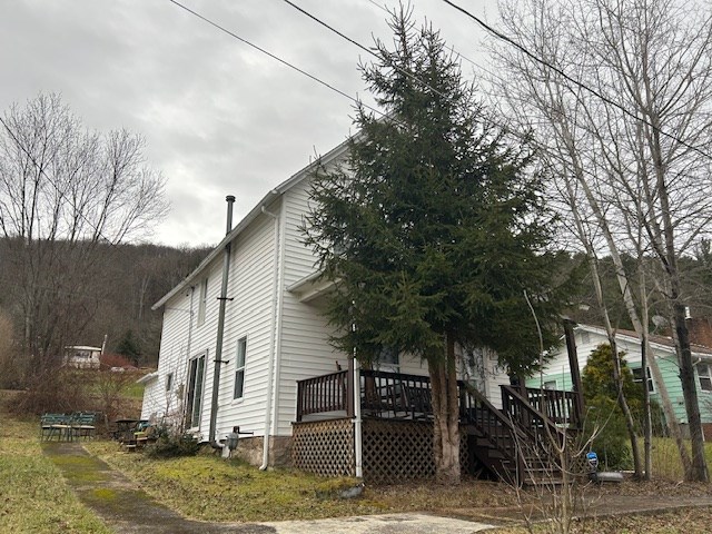 view of side of property featuring a deck