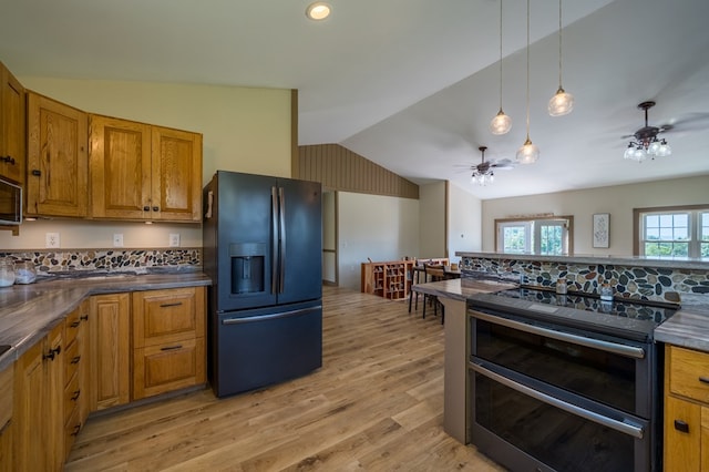 481 Case Rd, Sayre, PA 18840 - kitchen with black fridge with ice dispenser, range with two ovens, ceiling fan, vaulted ceiling, and dark countertops