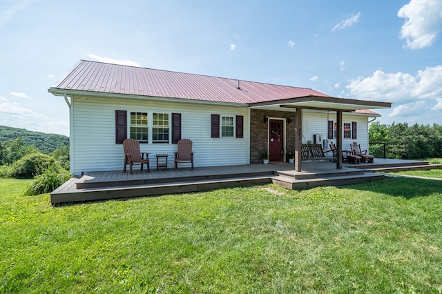 481 Case Rd, Sayre, PA 18840 - back of property featuring a lawn, a metal roof, a wooden deck, and stone siding