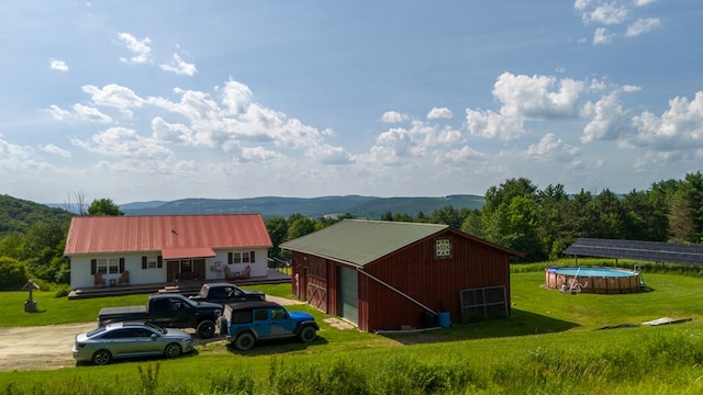 481 Case Rd, Sayre, PA 18840 - exterior space featuring a detached garage, an outdoor structure, a metal roof, an outbuilding, and a mountain view