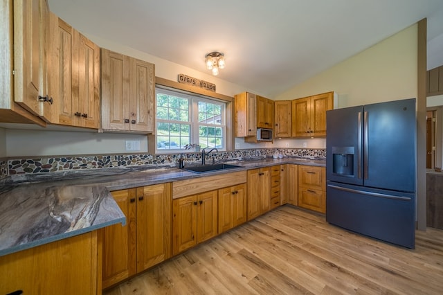481 Case Rd, Sayre, PA 18840 - kitchen with refrigerator with ice dispenser, vaulted ceiling, light wood-style flooring, and brown cabinetry
