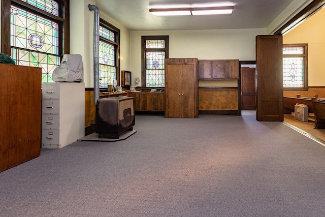 miscellaneous room featuring plenty of natural light and wainscoting