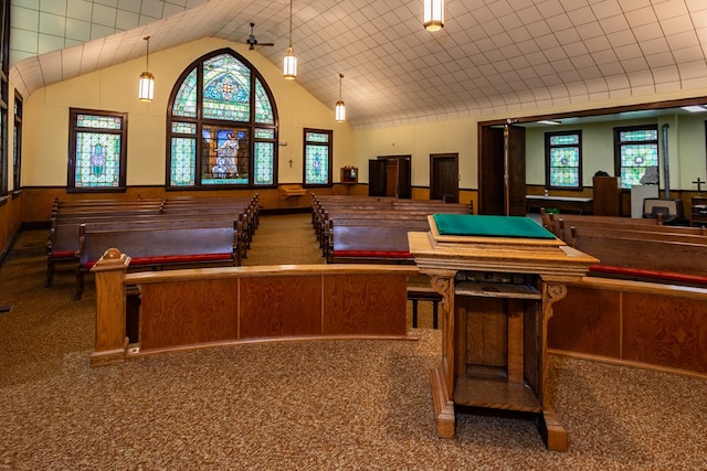 recreation room with high vaulted ceiling and carpet flooring