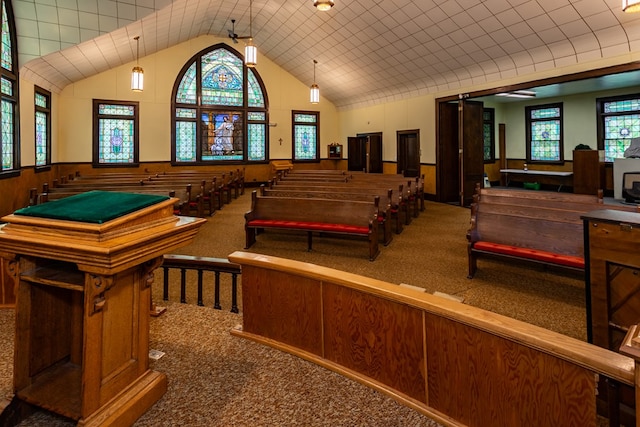 miscellaneous room with vaulted ceiling, carpet, and wainscoting