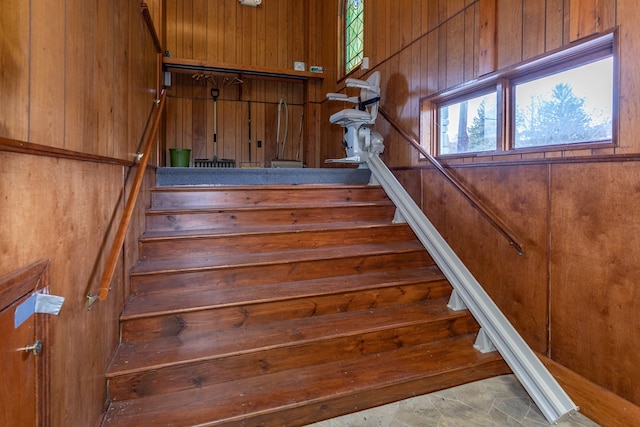 stairs featuring wooden walls