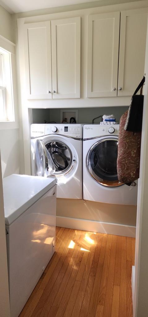 30 S Academy St, Mansfield, PA 16933 - clothes washing area featuring wood finished floors, cabinet space, and washing machine and clothes dryer