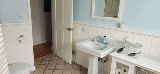 30 S Academy St, Mansfield, PA 16933 - bathroom with a sink, a wainscoted wall, tile patterned flooring, and toilet