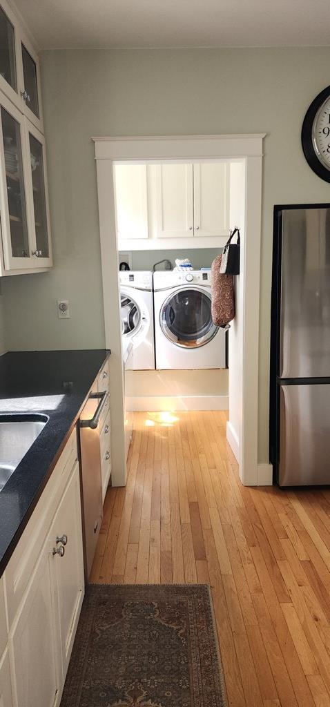 30 S Academy St, Mansfield, PA 16933 - clothes washing area with light wood-type flooring, cabinet space, and washing machine and clothes dryer
