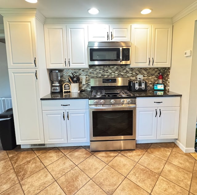 106 Magnolia St, Athens, PA 18810 - kitchen with appliances with stainless steel finishes, decorative backsplash, white cabinetry, light tile patterned flooring, and recessed lighting