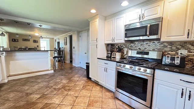 106 Magnolia St, Athens, PA 18810 - kitchen with stainless steel appliances, backsplash, white cabinetry, crown molding, and recessed lighting