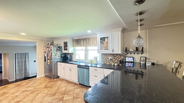106 Magnolia St, Athens, PA 18810 - kitchen with stainless steel appliances, tasteful backsplash, white cabinets, glass insert cabinets, and crown molding